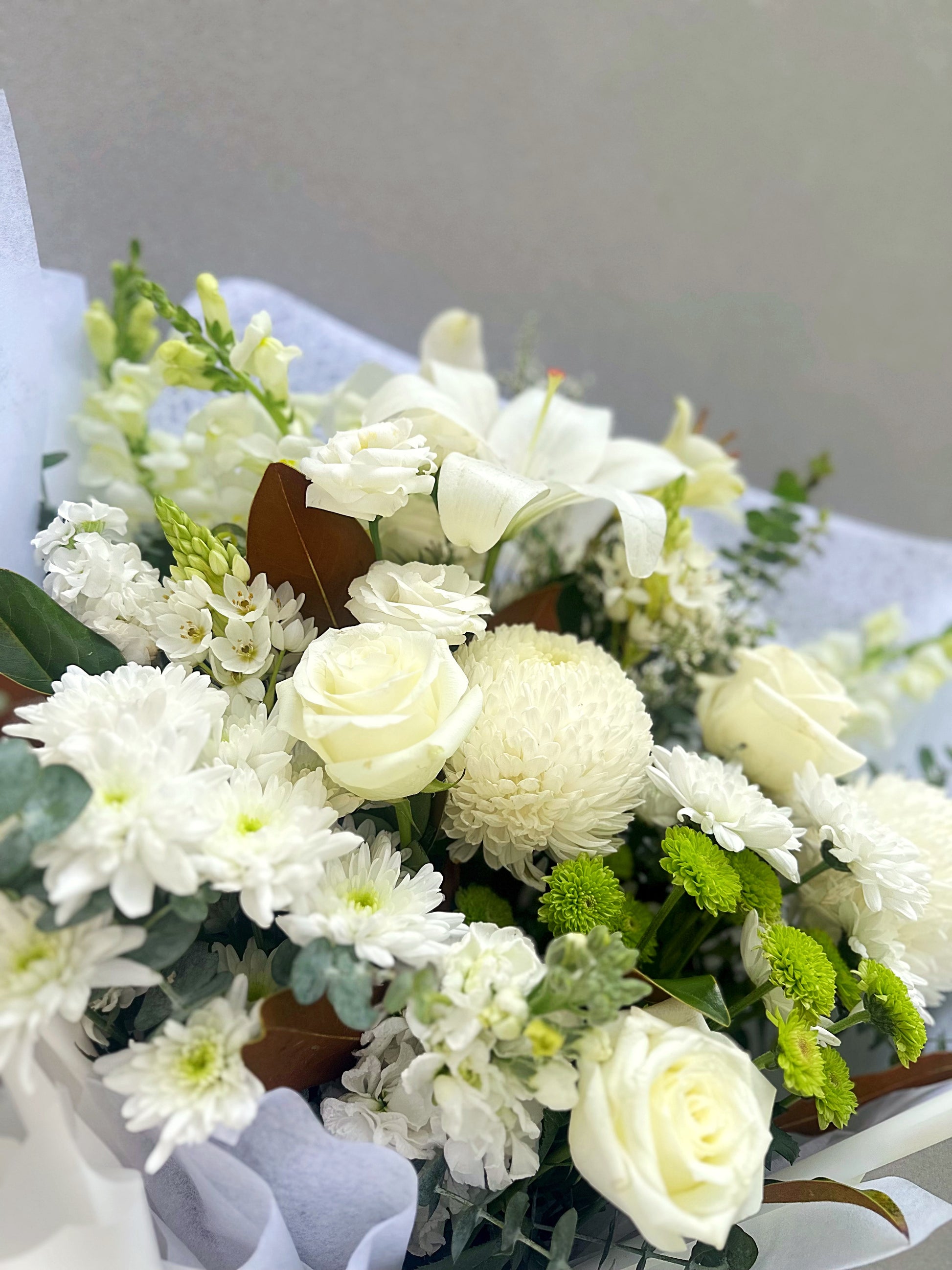 Elegant white Sympathy Bouquet wrapped in white paper - Hills District Sydney Florist