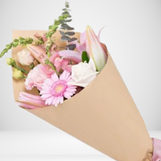 Posy of flowers wrapped in brown paper on a light background