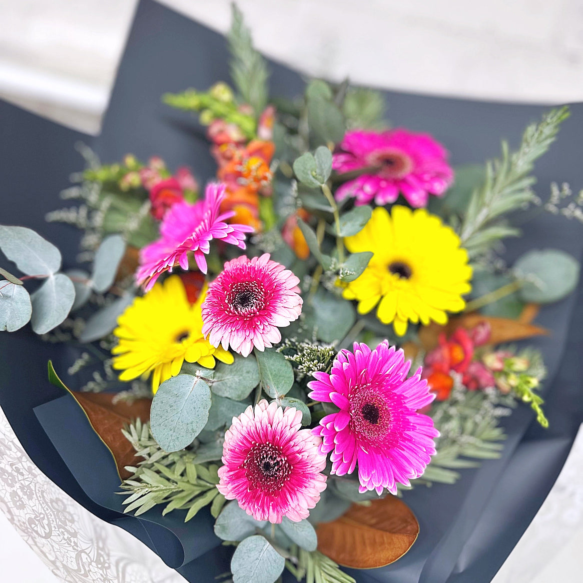Gerbera bouquet with vibrant blooms, lush foliage and joyful colour — designed for maximum impact and same-day delivery across Sydney.