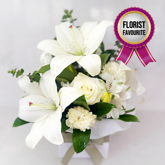Sympathy and condolence flower arrangement of white lilies, roses and carnations | same day flower delivery Hills District