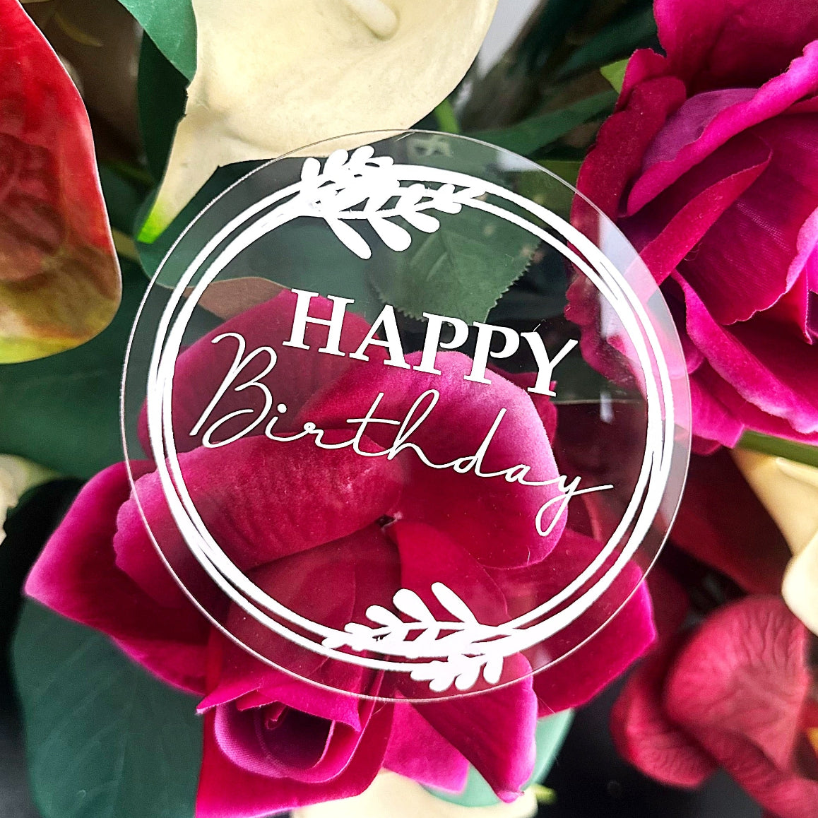 Acrylic round plaque with happy birthday message added to flower arrangement.