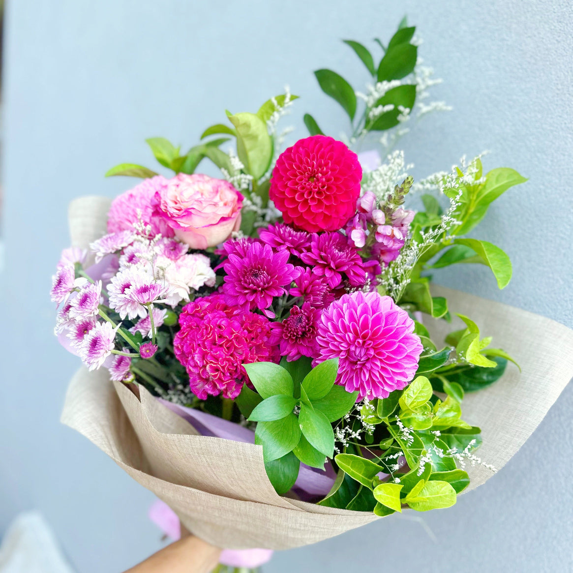 Garden style pink bouquet wrapped in natural paper