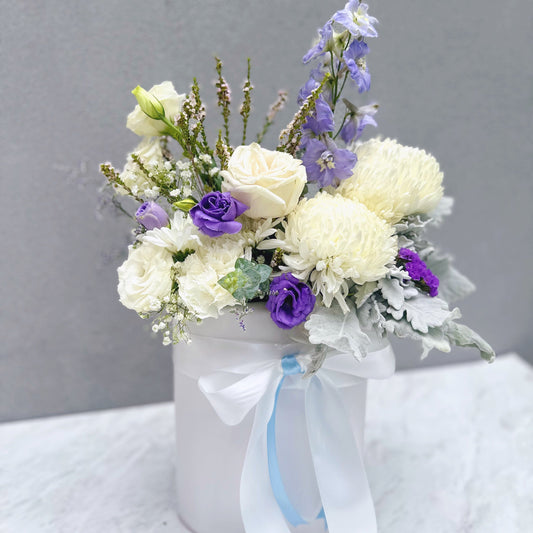Arrangement of white and purple flowers in a white vase | same Day hospital flower delivery Sydney